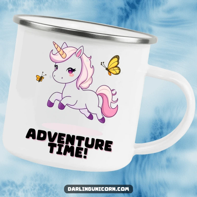 Funny camping mug showing a unicorn leaping joyfully while playing tag with a butterfly, perfect for outdoor playfulness.