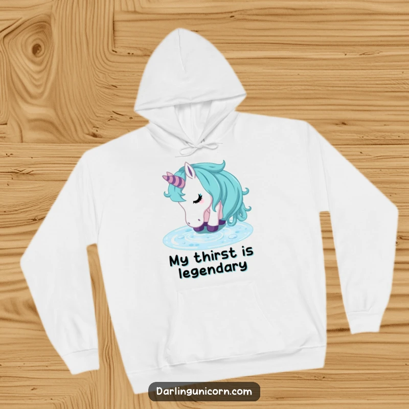 Funny unicorn hoodie showing a tranquil unicorn looking refreshed after drinking from a crystal clear stream, perfect for cozy, peaceful moments.