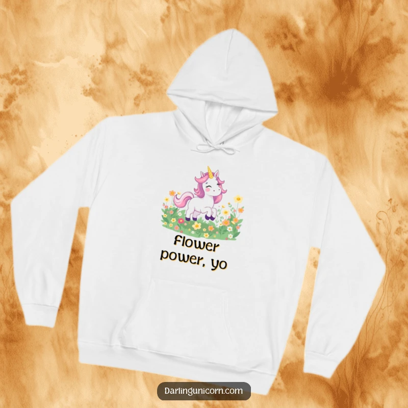 Funny hoodie featuring a happy unicorn galloping joyfully through a field of radiant, glowing flowers, perfect for cozy, magical days.