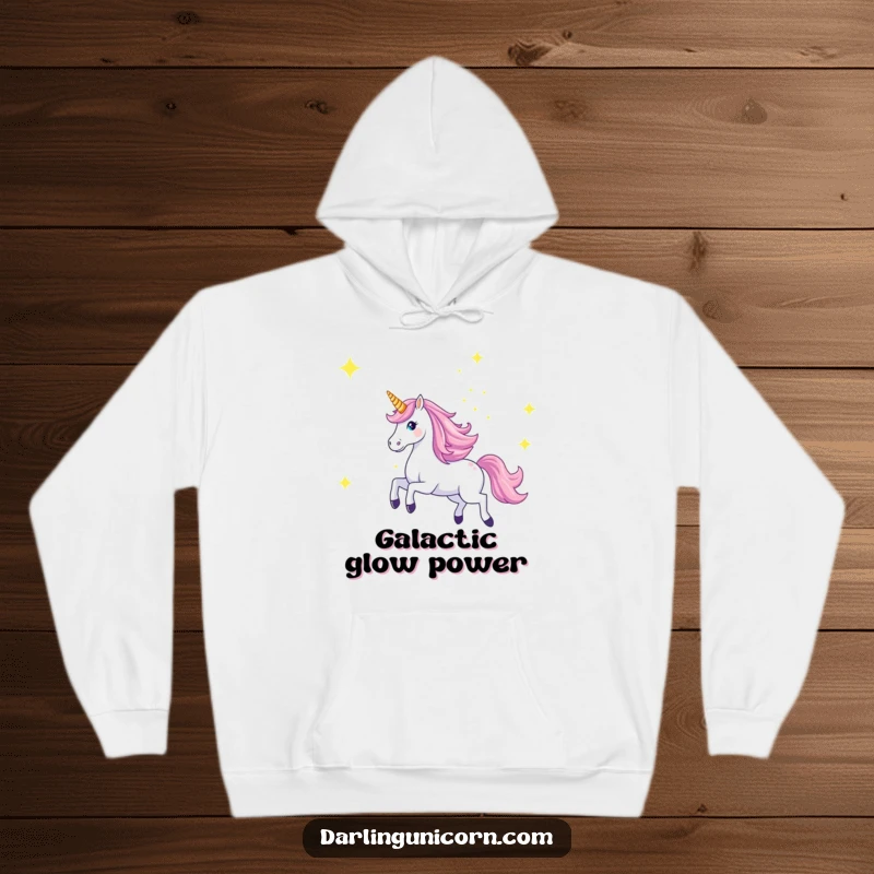 Funny hoodie depicting a majestic unicorn galloping across a starry sky with its horn aglow, perfect for cozy nights and dreams.