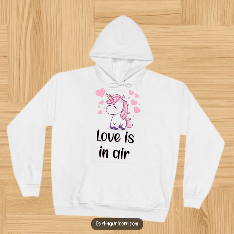 Funny Hoodie: A unicorn blows a kiss, showering the area with sparkling hearts, creating a humorous and loving atmosphere.