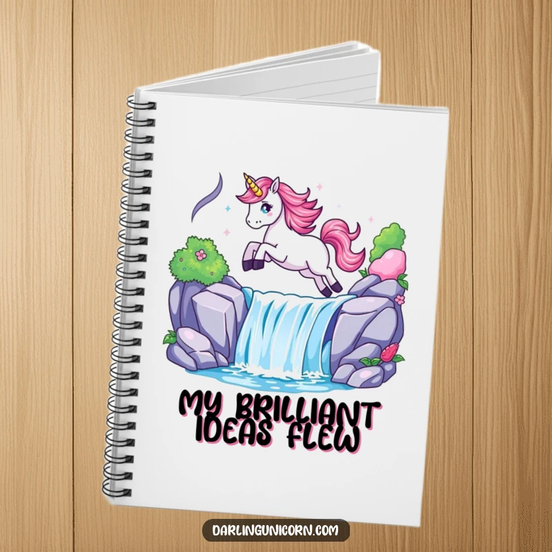 Funny notebook cover with a unicorn leaping dynamically over a radiant waterfall, encouraging creative and magical writing.