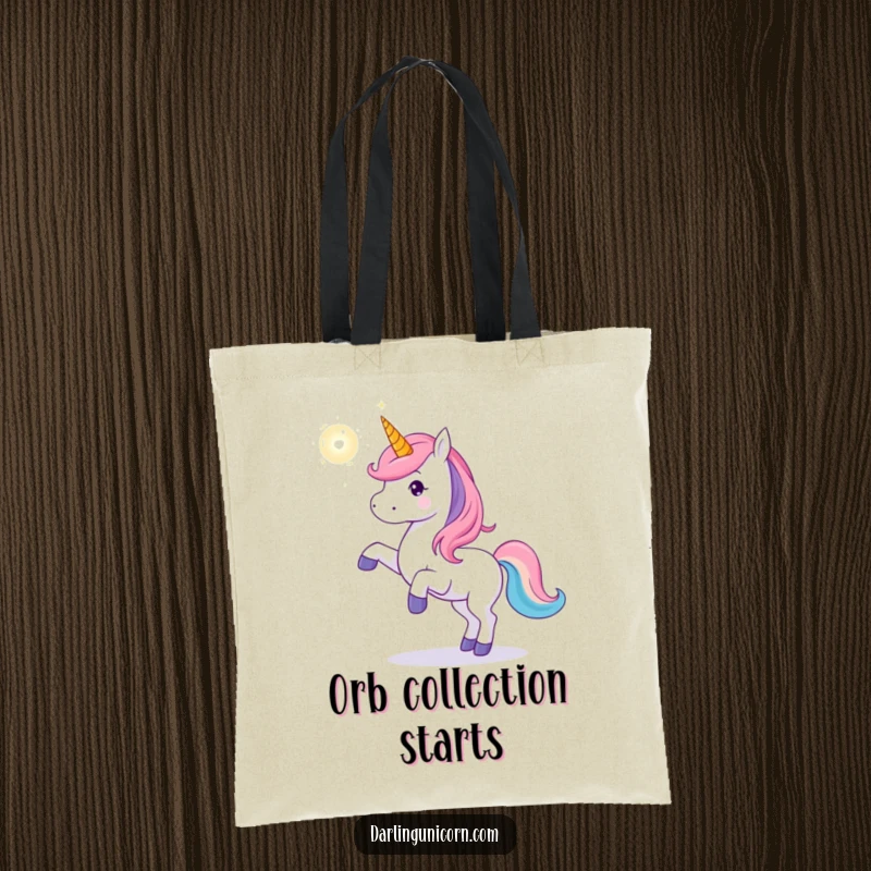 Funny unicorn tote bag depicting a unicorn playfully tossing a glowing magical orb, perfect for carrying treasures with a touch of fantasy.